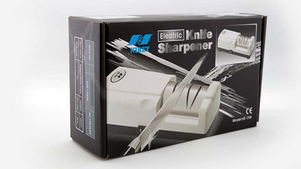 Boxed electric knife sharpener product with an image of the sharpener on the front and blades in the foreground (brand visible).﻿ Read as: Electric Knife Sharpener on packaging.