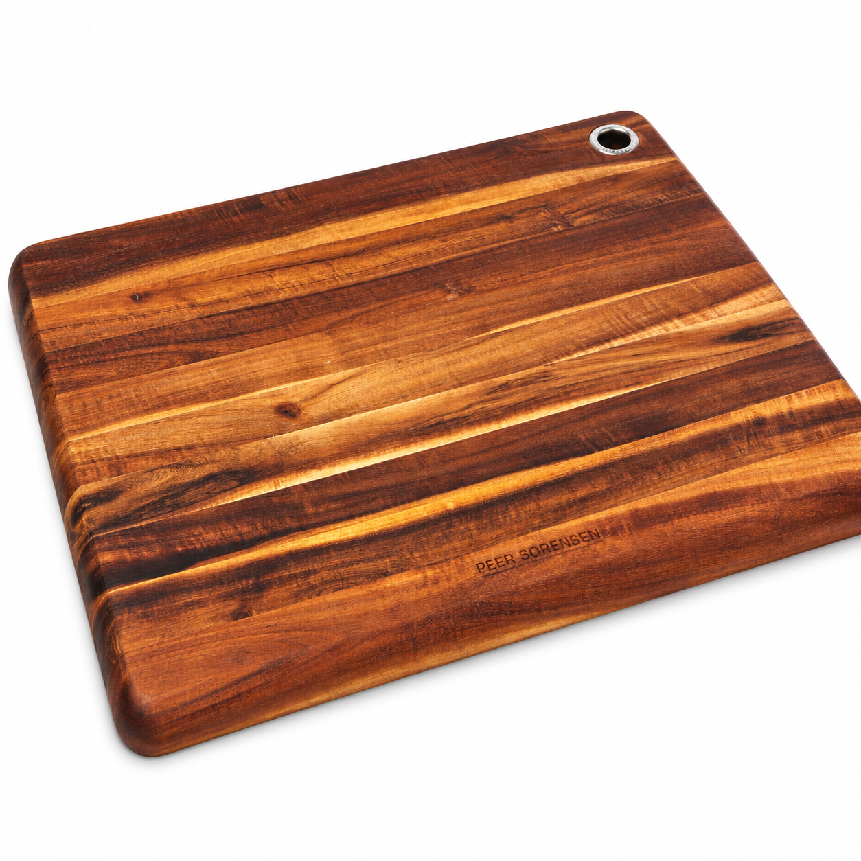 Wooden cutting board with a warm grain pattern and a hanging hole in the corner; engraved 'PEER SORENSEN'.